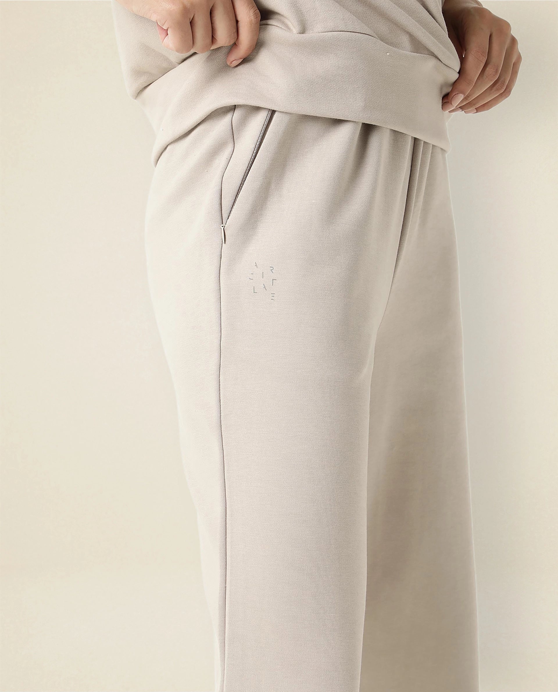 Rareism Women Capsule Beige Cotton Blend Fabric Relaxed Fit Solid Mid Rise Ankle Length Track Pant