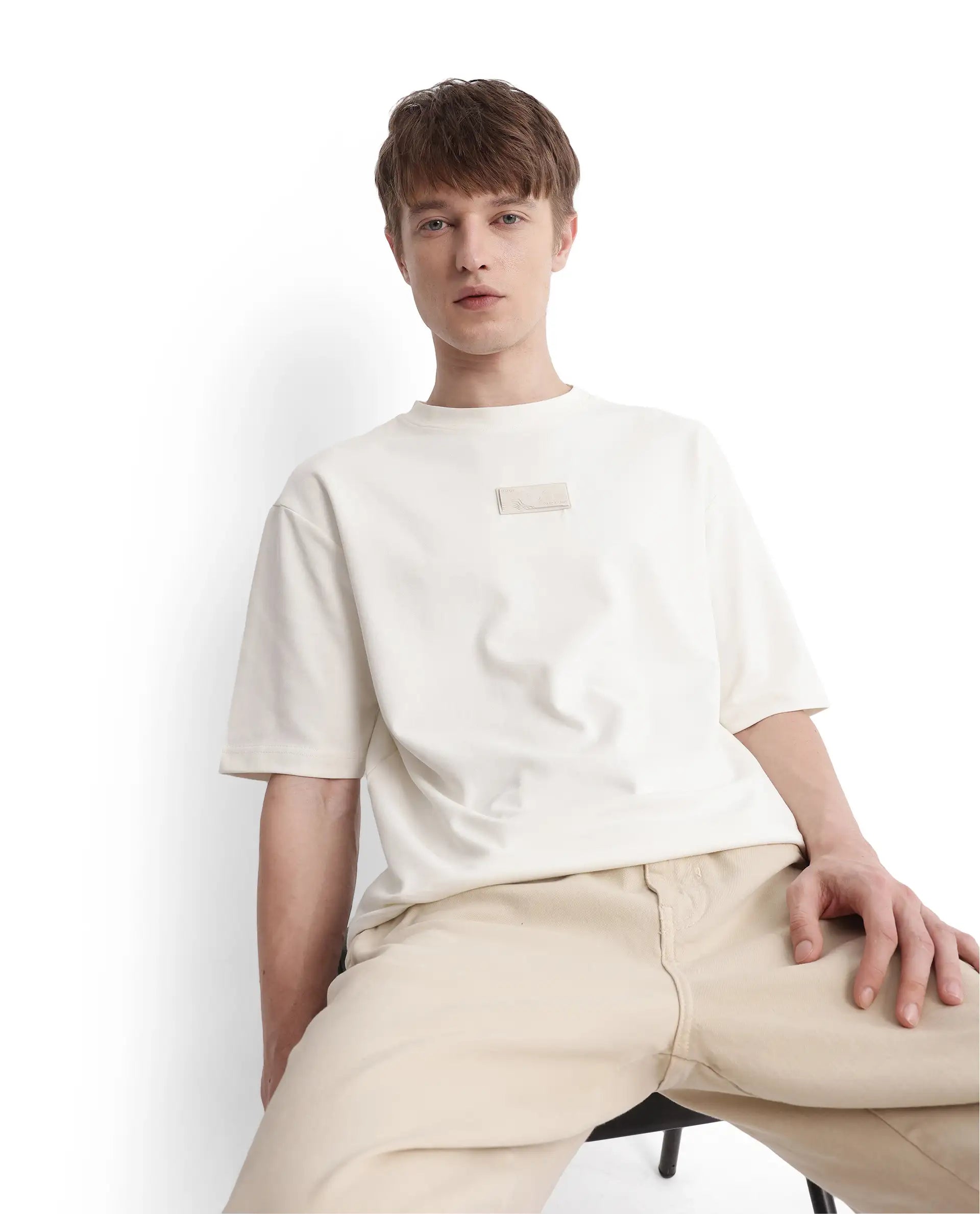 Rare Rabbit Men Endy Off White Cotton Poly Fabric Short Sleeve Boxy Fit Silicone Badge Branding T-Shirt