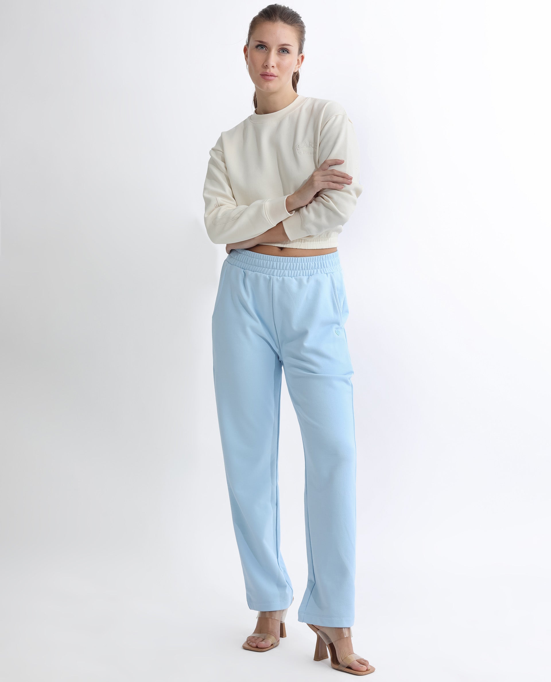 Rareism Women Fronk Light Blue Poly Cotton Fabric Tailored Fit Solid Mid Rise Ankle Length Track Pant