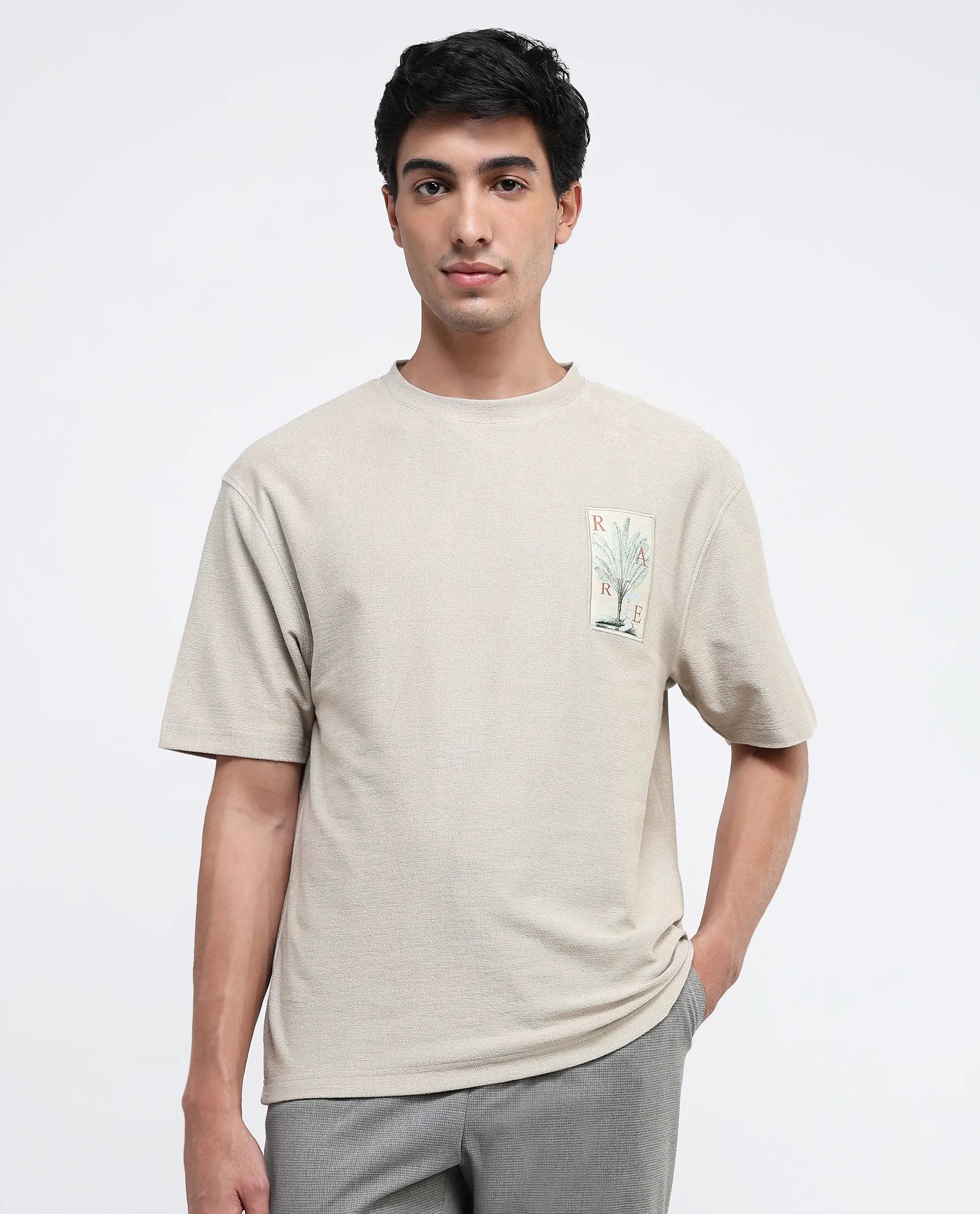 Rare Rabbit Men Loopet-1 Beige Cotton Lycra Fabric Half Sleeves Floral Print Pocket Detailing Oversized Fit Solid T-Shirt