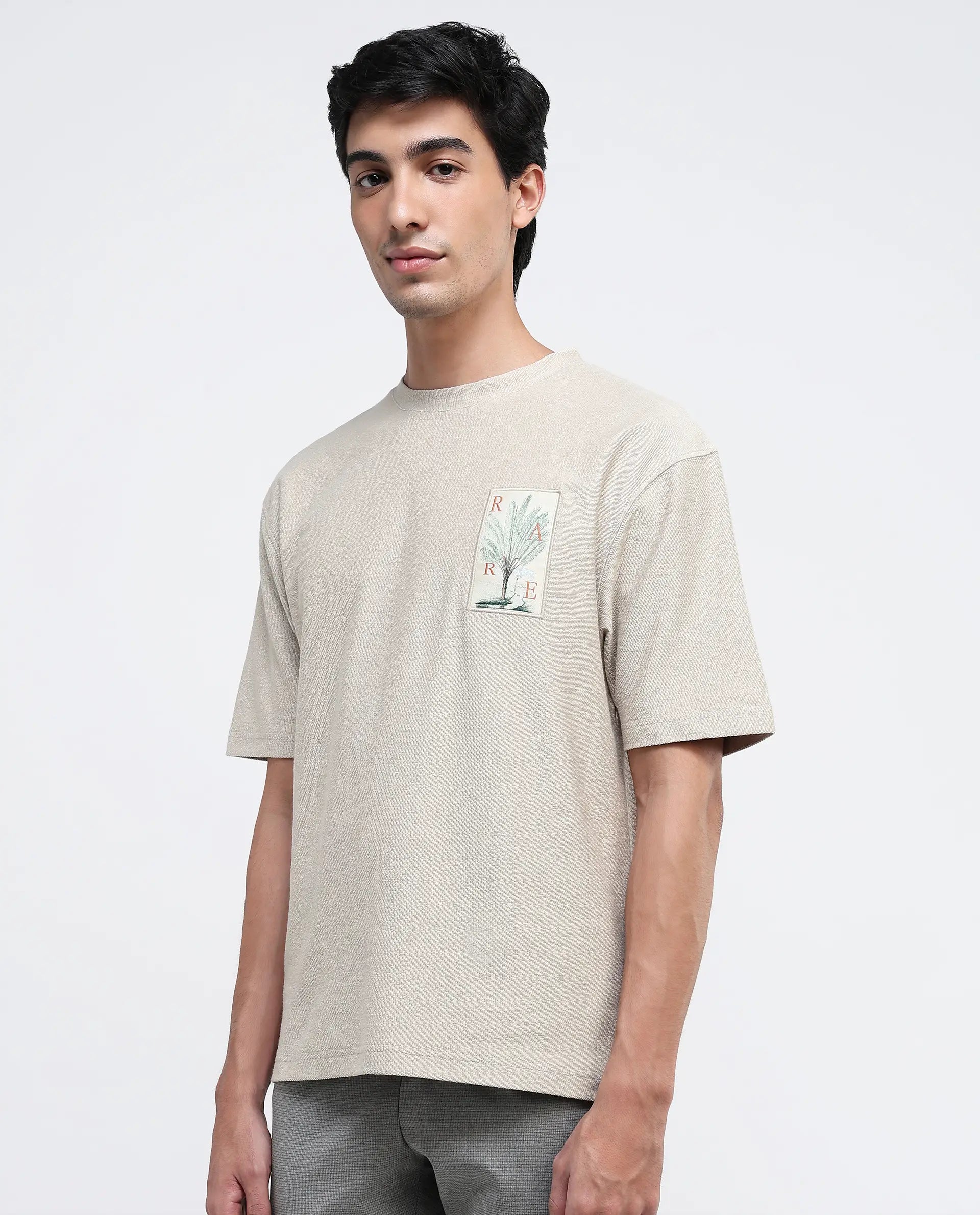 Rare Rabbit Men Loopet-1 Beige Cotton Lycra Fabric Half Sleeves Floral Print Pocket Detailing Oversized Fit Solid T-Shirt