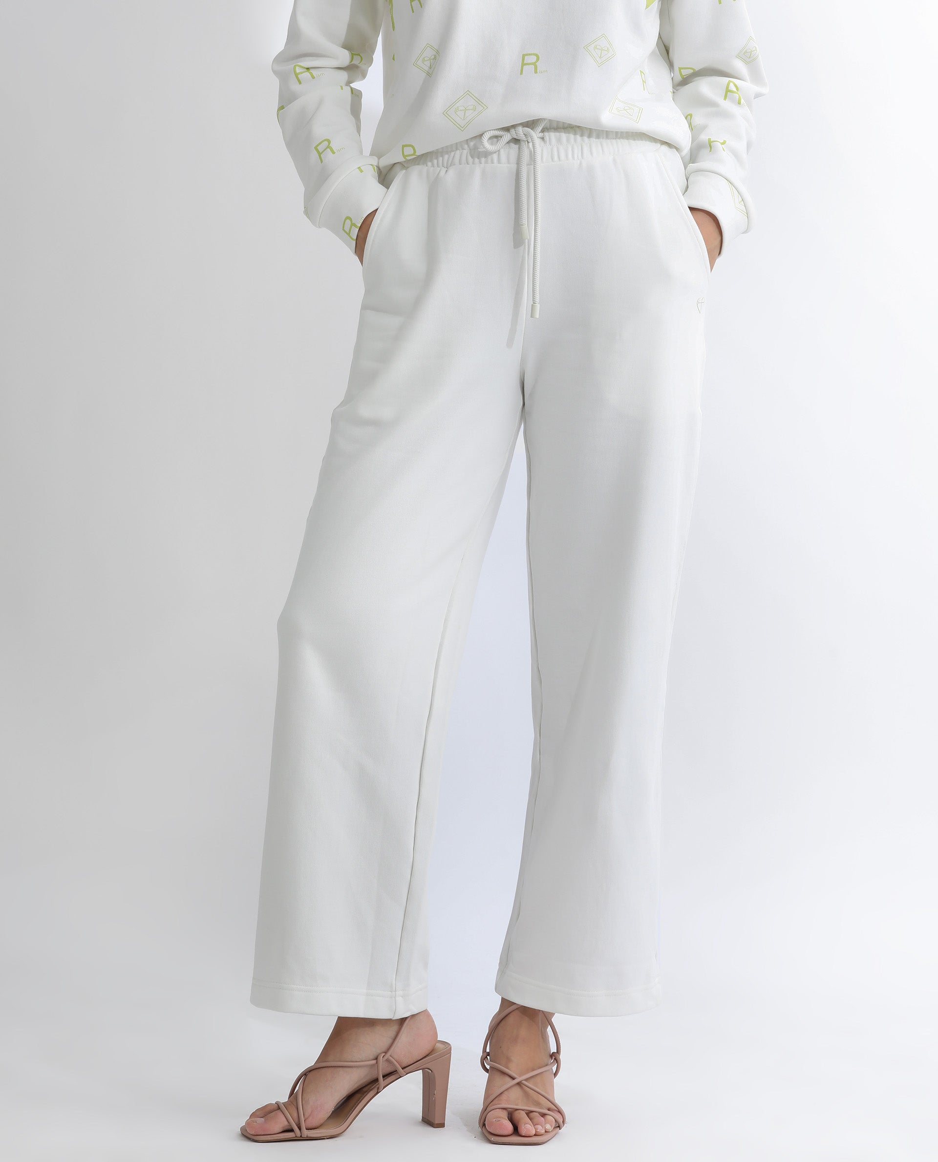 Rareism Women Pazoo T Off White Cotton Blend Fabric Flared Solid Mid Rise Ankle Length Track Pant