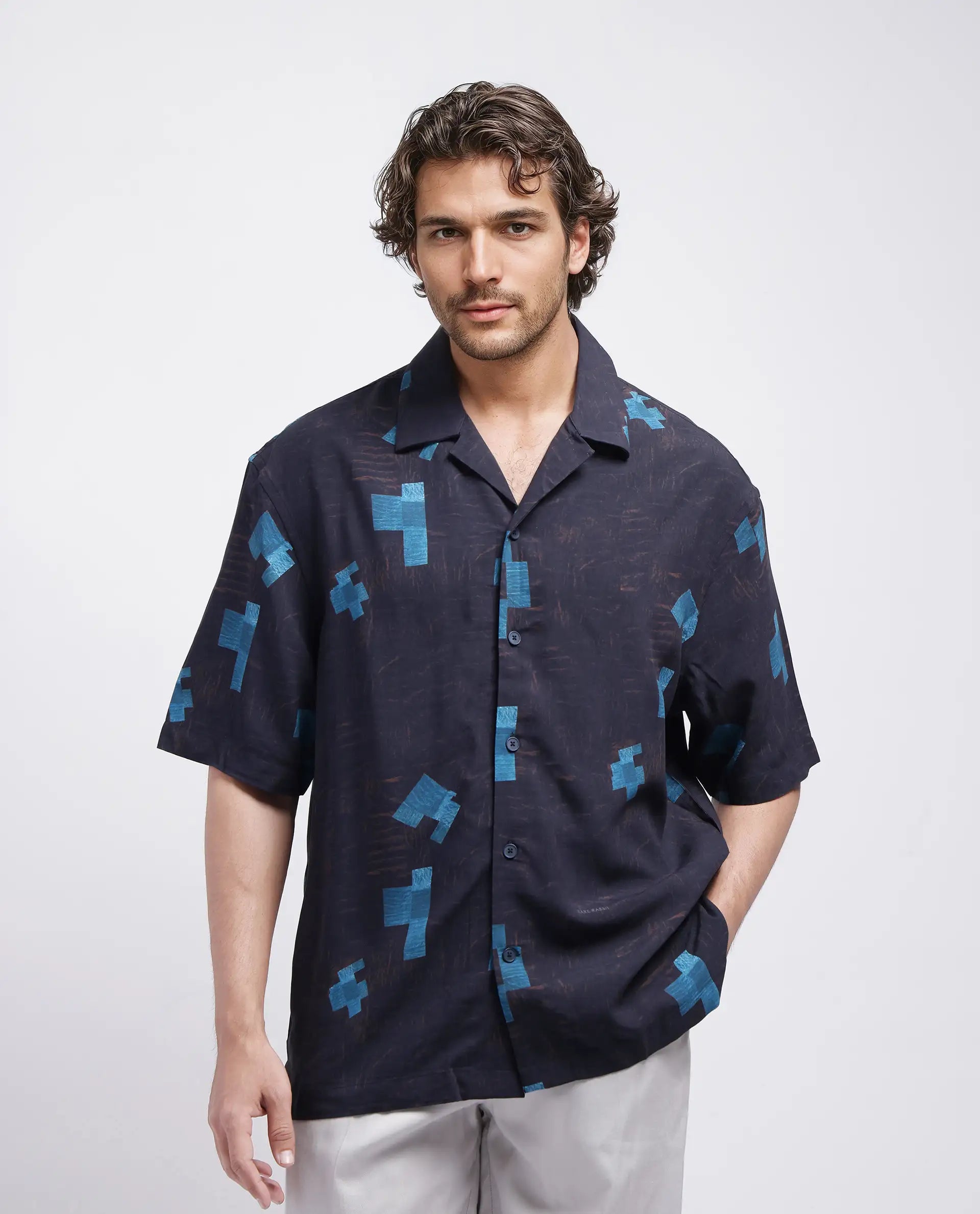 Rare Rabbit Men Riko Dark Brown Viscose Fabric Half Sleeve Cuban Collar Button Closure Oversized Fit Abstract Print Shirt