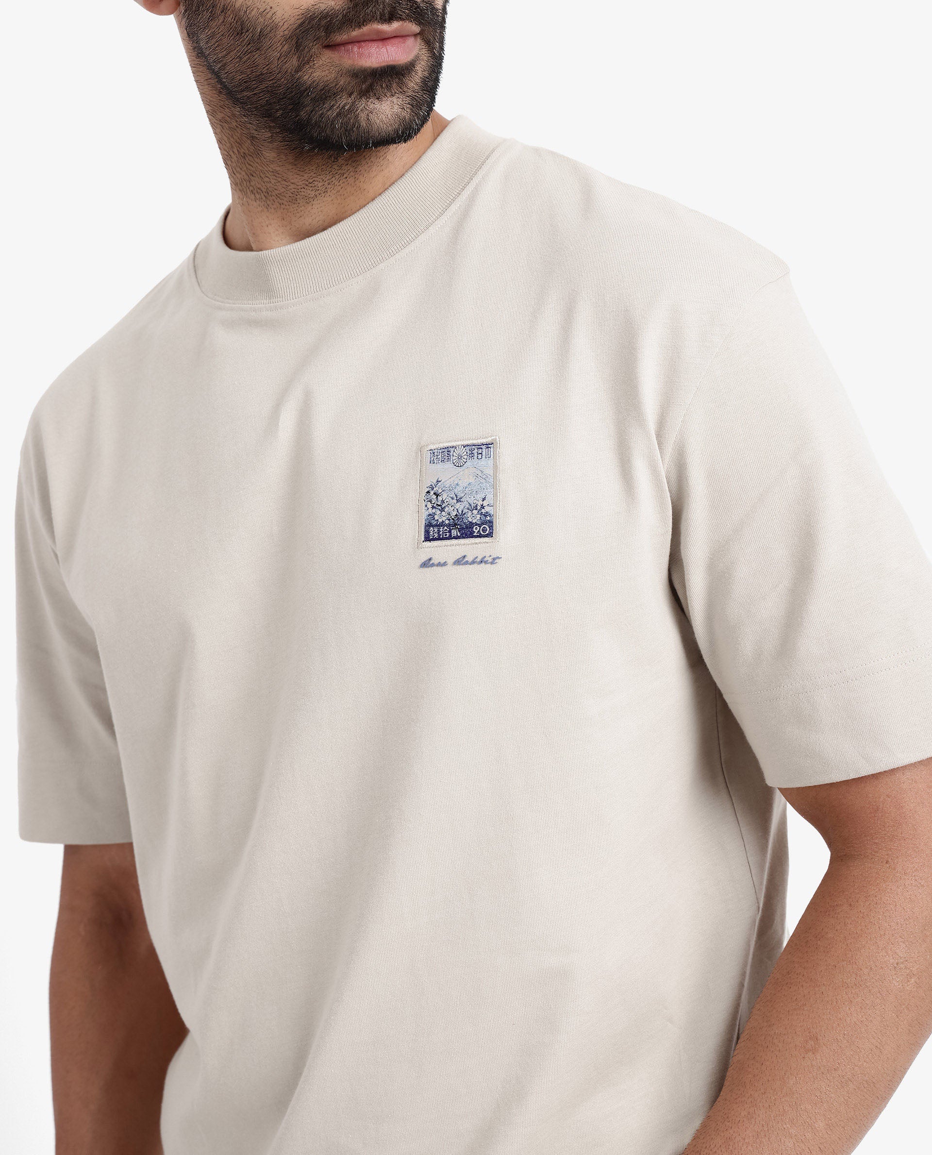 Rare Rabbit Men Trams Beige Cotton Fabric Short Sleeve Crew Neck Oversized Fit Graphic Print T-Shirt