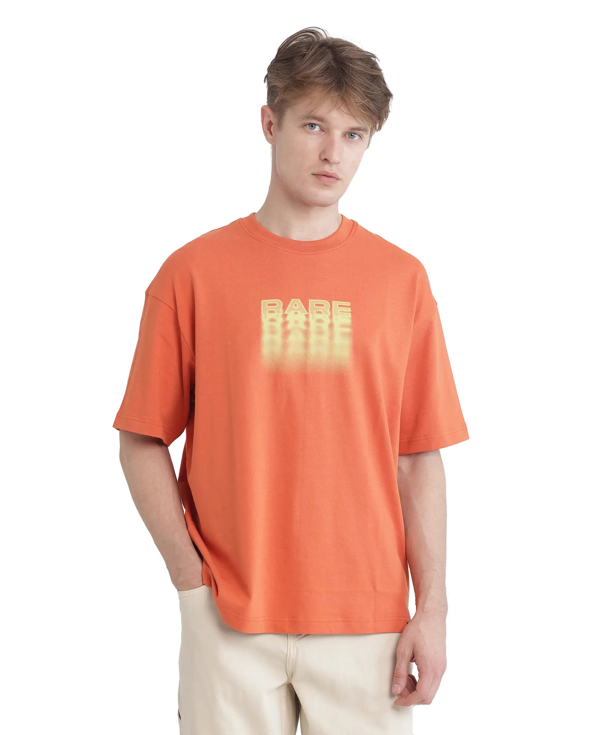 Rare Rabbit Men Act Orange Cotton Fabric Short Sleeve Crew Neck Slip-On Oversized Fit Graphic Print T-Shirt