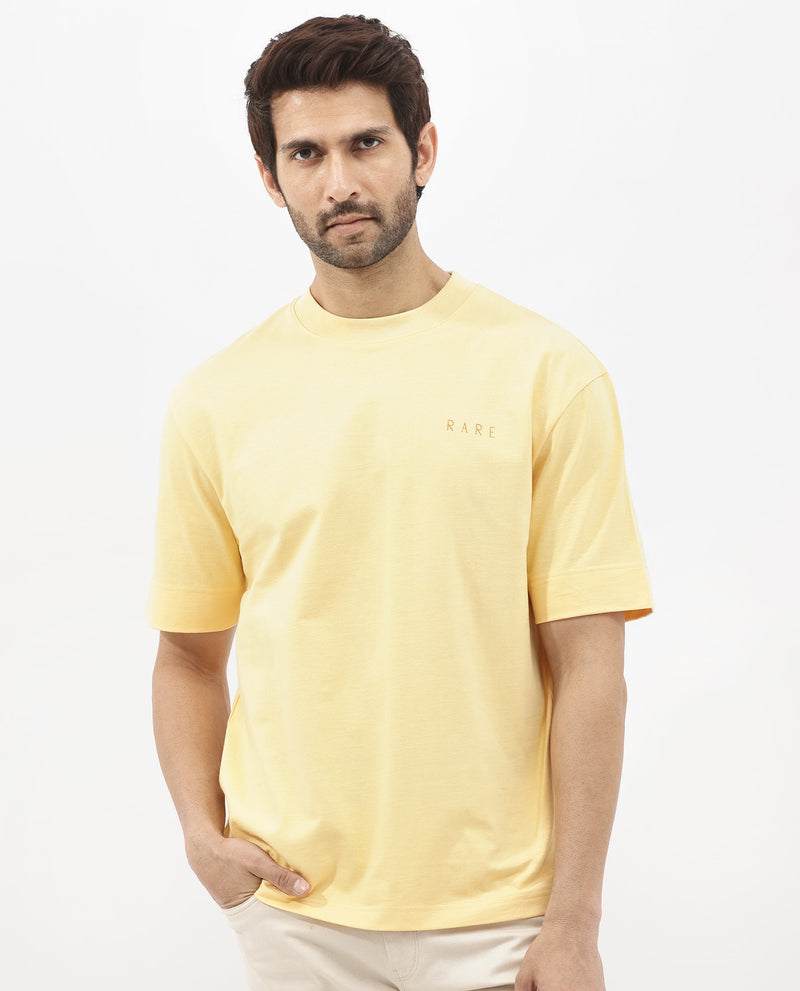 Rare Rabbit Articale Mens Beck Dusky Yellow Cotton Fabric Short Sleeve Crew Neck Oversized Fit Graphic Printed T-Shirt