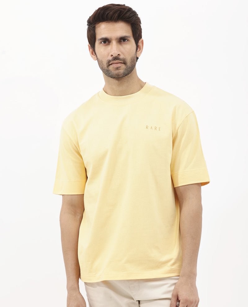 Rare Rabbit Articale Mens Beck Dusky Yellow Cotton Fabric Short Sleeve Crew Neck Oversized Fit Graphic Printed T-Shirt