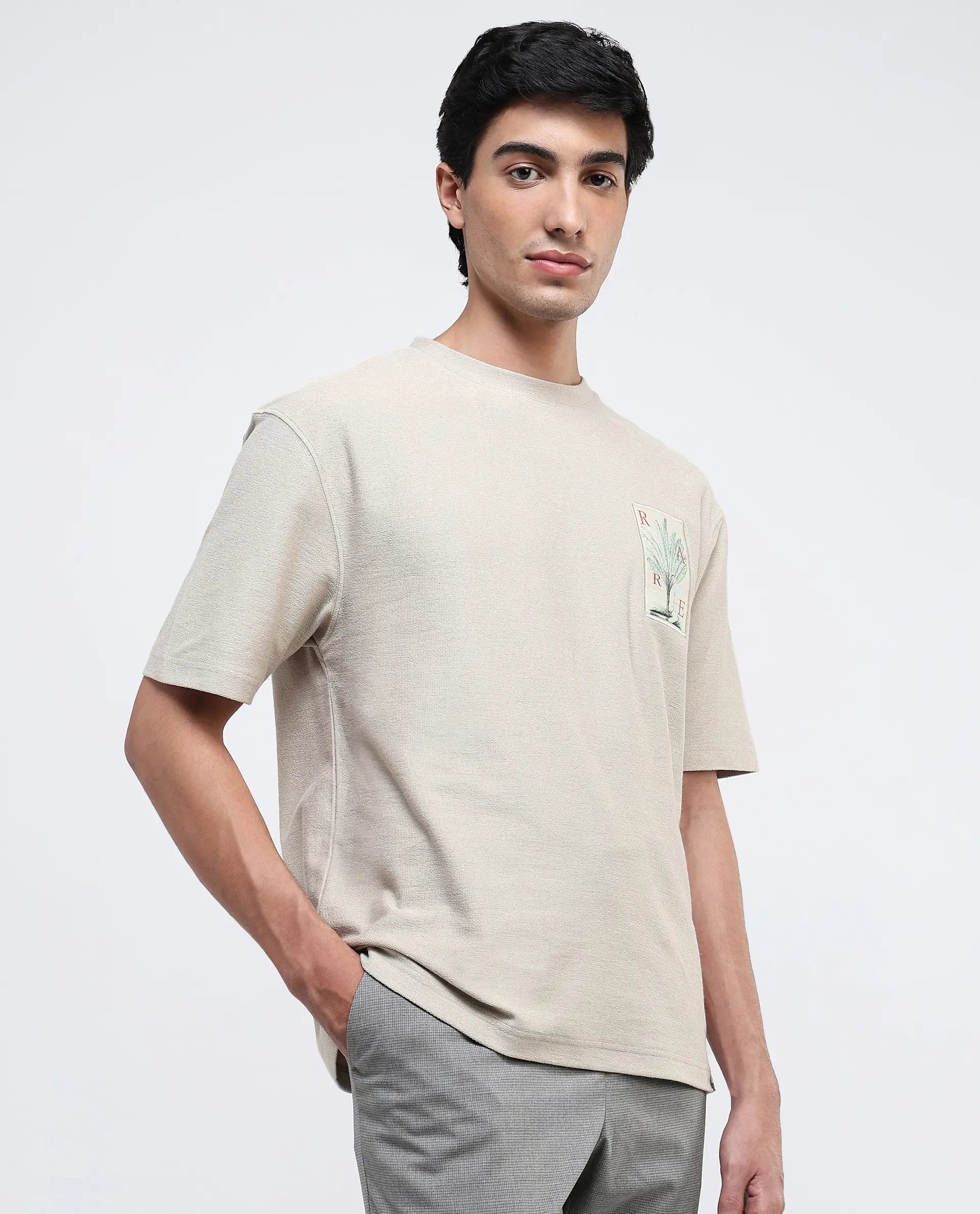 Rare Rabbit Men Loopet-1 Beige Cotton Lycra Fabric Half Sleeves Floral Print Pocket Detailing Oversized Fit Solid T-Shirt