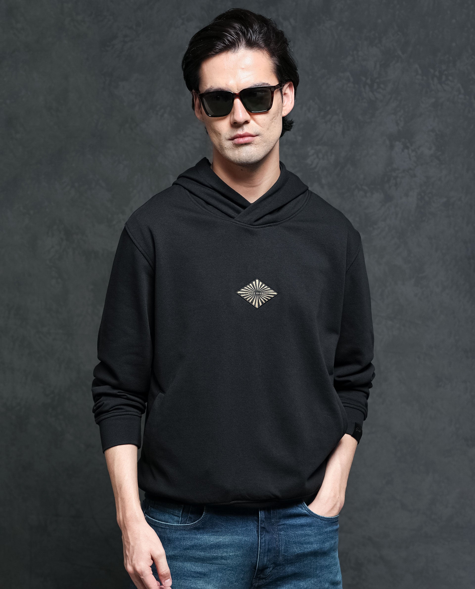 Rare Rabbit Men's Trivial Black Cotton Polyester Fabric Full Sleeves Logo Graphic Badge Hooded Sweatshirt