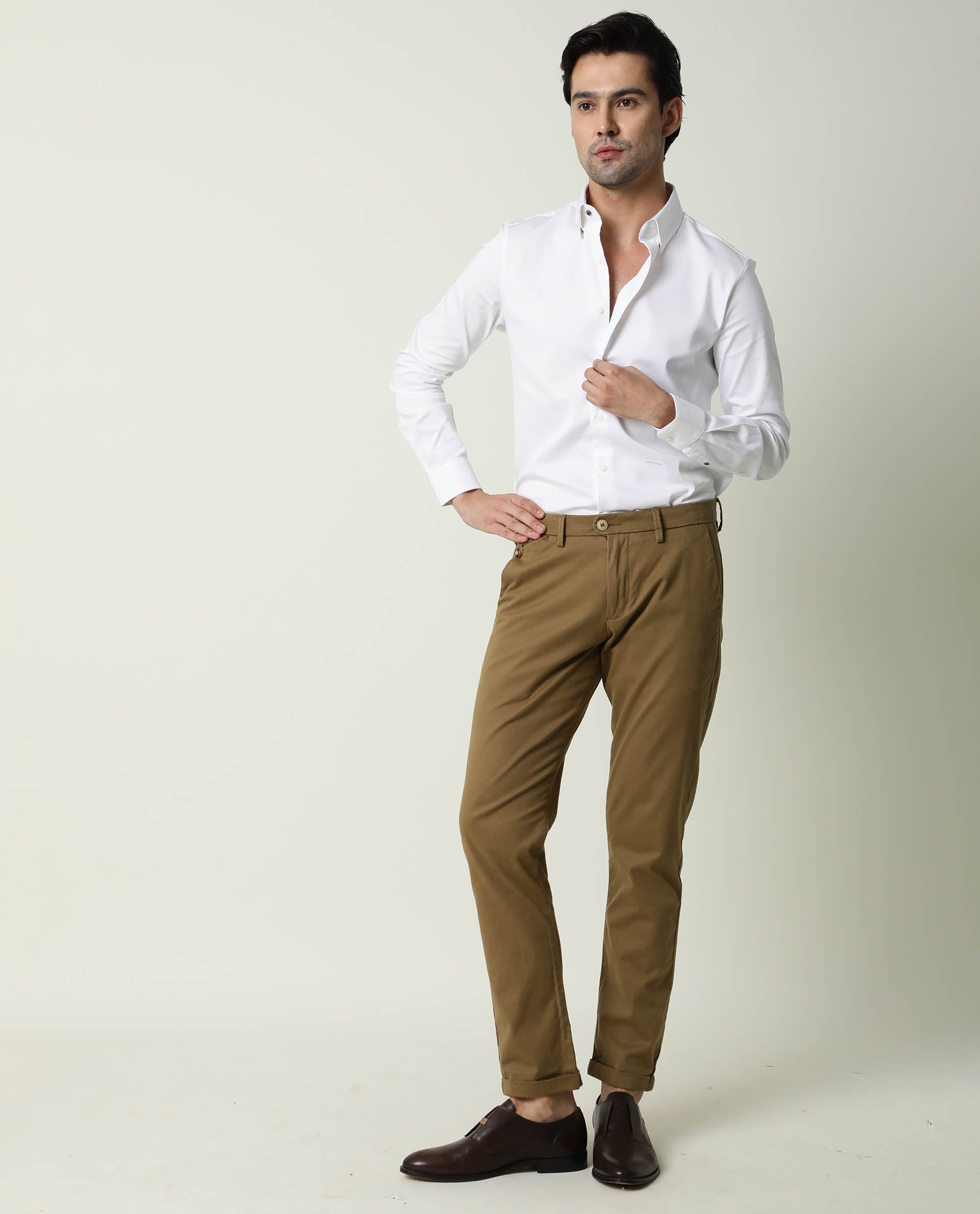white shirt and brown pants