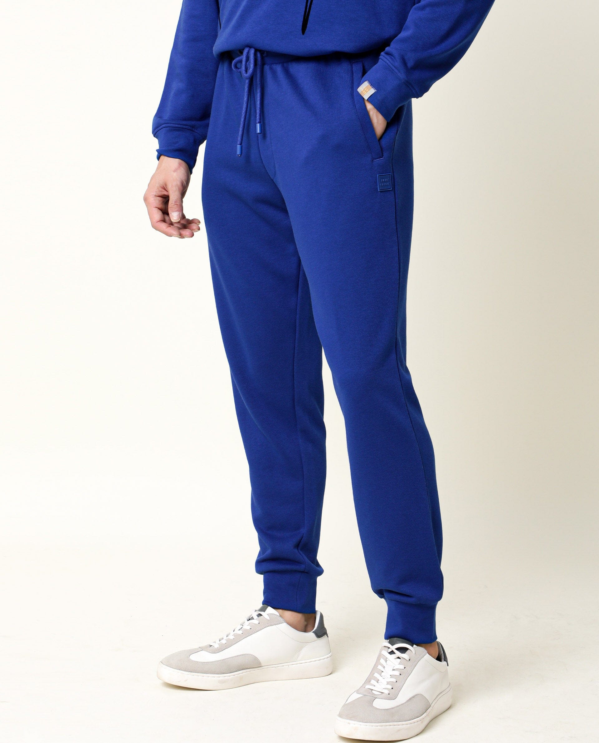 Rare Rabbit Men's Titan Fluorescent Blue Cotton Polyester Fabric Drawstring Slim Fit Track Pant